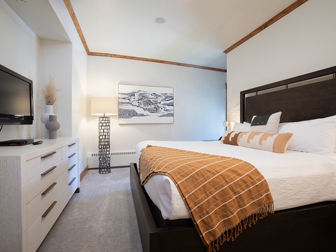 Sink into the plush bedding and unwind while watching your favorite shows. Warm wooden accents and soft lighting create a cozy retreat after your mountain adventures.