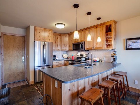 Your fully equipped kitchen features warm wood cabinetry, granite countertops, and stainless steel appliances. Gather around the spacious island for meals or morning coffee together.