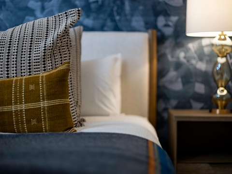 Sink into plush pillows and drift off beside the warm glow of your bedside lamp—your peaceful retreat awaits.