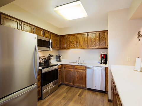 Your fully equipped kitchen features stainless steel appliances, rich wood cabinetry, and everything you need to prepare meals just the way you like them during your stay.
