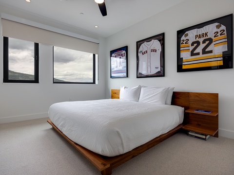 Unwind in your bright, modern bedroom with crisp linens, warm wood touches, and peaceful views that promise restful nights.
