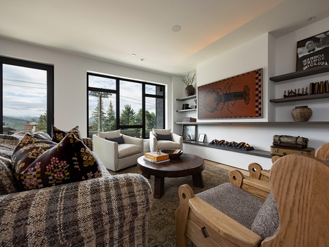 Sink into your private living area and enjoy mountain views through expansive windows. Warm textures, curated art, and thoughtful design create your perfect retreat.