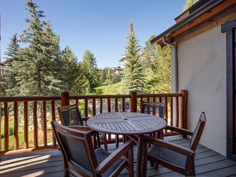 Step onto your private balcony and breathe in the fresh mountain air. Enjoy morning coffee or evening drinks at your cozy table, surrounded by towering evergreens and peaceful hillside views.