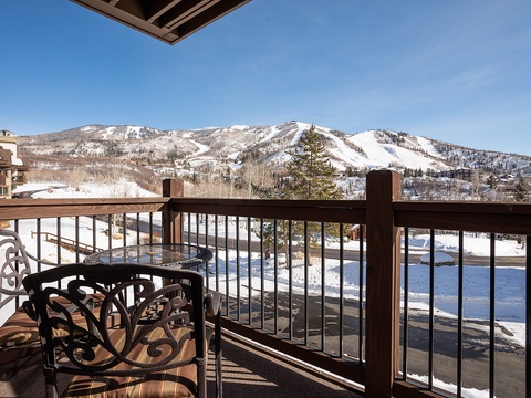 Stunning panoramic mountain and ski slope views frame this private balcony, perfect for your morning coffee or après-ski relaxation under crisp blue skies.