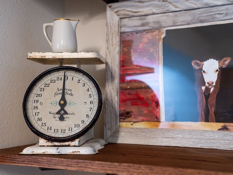 Charming farmhouse touches bring warmth to your stay—vintage scales and rustic artwork create an inviting, nostalgic atmosphere in this thoughtfully decorated space.