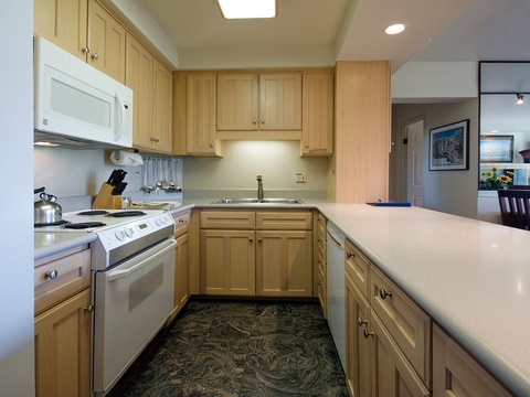 Your fully equipped kitchen features warm maple cabinetry, modern appliances, and ample counter space—perfect for preparing your favorite meals during your stay.
