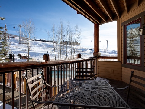 A mountain resort located near ski slopes with gondola access and bare winter trees surrounding the property.