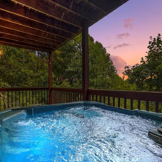 Unwind in your private hot tub as twilight paints the sky in stunning colors above the lush forest canopy.