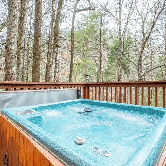Soak in your private hot tub surrounded by peaceful woodland views, perfect for unwinding after exploring.