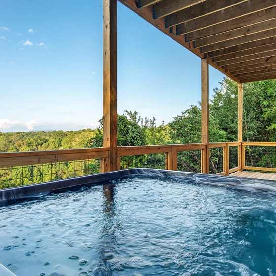 Soak in your private hot tub surrounded by lush treetops, where the only sounds are birdsong and rustling leaves. A peaceful retreat with sweeping forest views, perfect for unwinding after a day of adventure.
