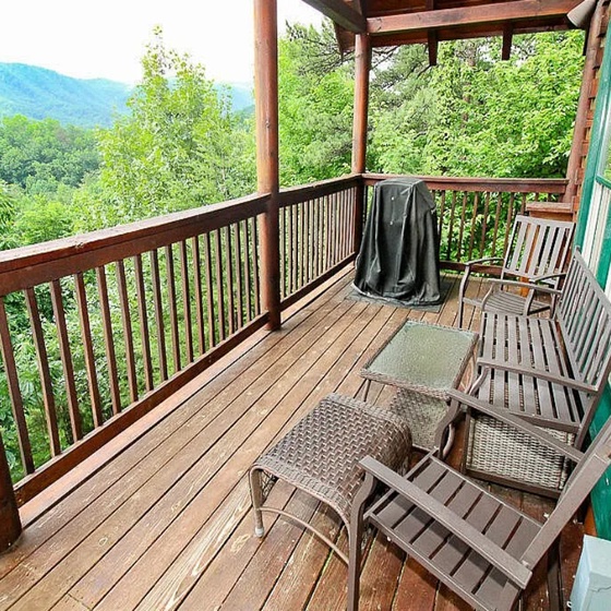 Your private deck offers the perfect spot to unwind, with cozy seating and a grill ready for a relaxing evening surrounded by lush forest and mountain vistas.
