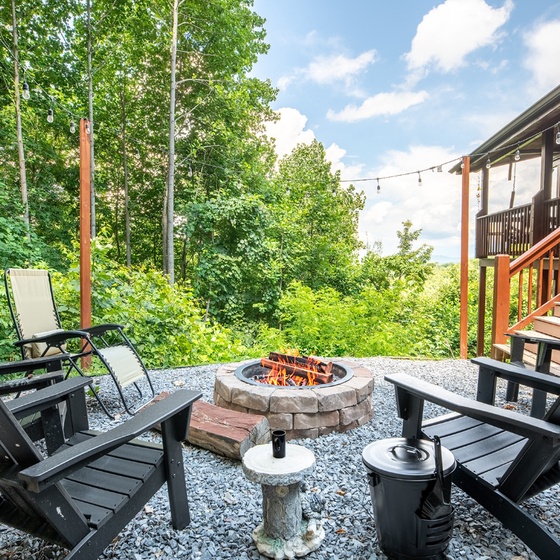 Gather around the crackling fire pit on your private patio, surrounded by forest views and cozy seating—perfect for evening conversations under the stars or morning coffee in nature's embrace.