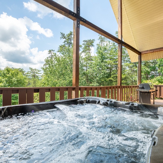 Soak in your private hot tub as you gaze out at lush forest views and rolling mountains. Warm bubbles, fresh air, and a stunning natural backdrop await your relaxation.