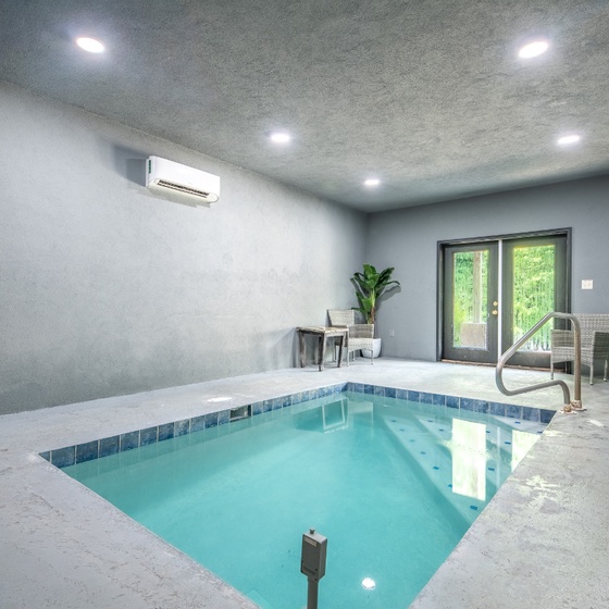 Step into your private indoor pool sanctuary, where natural light streams through glass doors and lush greenery creates a serene escape for relaxation and rejuvenation.