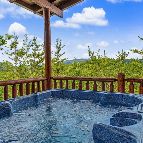 Soak in your private hot tub while soaking up sweeping mountain vistas under a sunny sky—pure relaxation awaits on your covered deck.