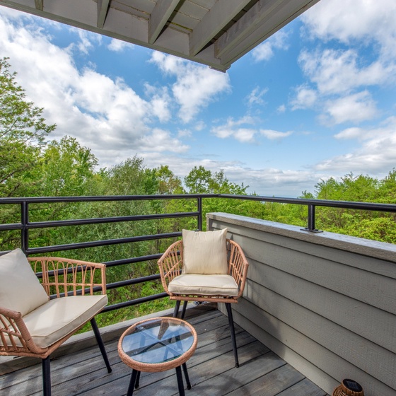Sip your morning coffee on your private balcony with sweeping views of lush greenery and blue skies—the perfect spot to unwind and breathe in fresh air.