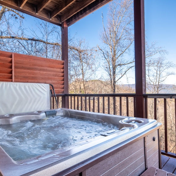 Soak away your stress in your private hot tub while taking in stunning mountain views from this peaceful covered deck.