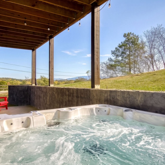 Soak in your bubbling hot tub under the covered back patio, where rolling hills and mountain vistas stretch to the horizon.