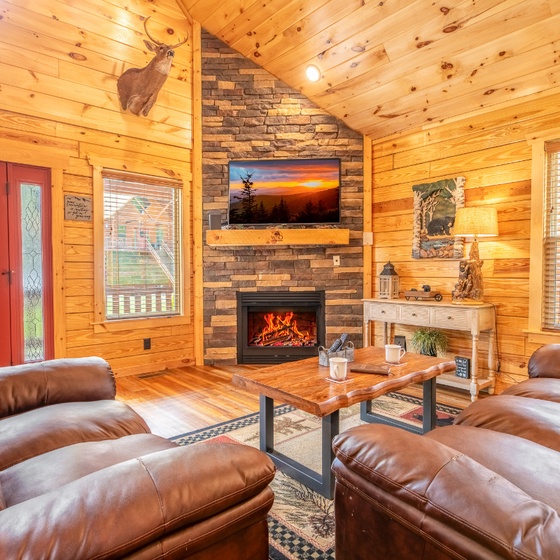 Relax in a warm, open living space with soaring ceilings and a cozy fireplace