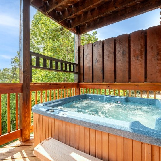 Slip into your private hot tub and soak while breathing in fresh mountain air and leafy treetop views stretching into the distance.
