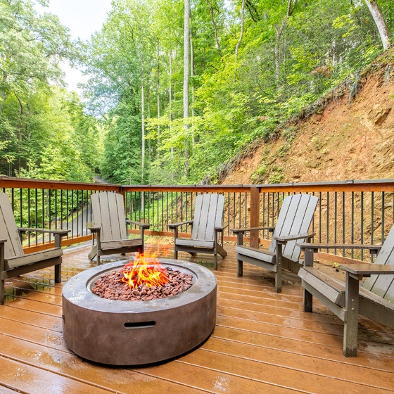 Gather around the fire on your private deck, surrounded by lush forest views and the peaceful sounds of nature.
