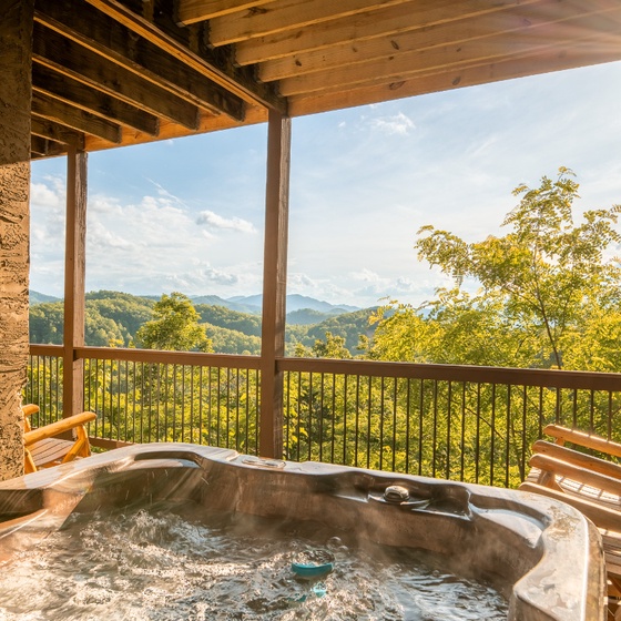 Unwind in your private hot tub on the covered deck as you soak in breathtaking mountain vistas under warm sunlight and open skies.