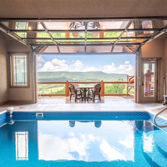 Dive into your private indoor pool and soak in stunning mountain vistas. The glass garage door opens to a deck where you can dine al fresco surrounded by natural beauty.