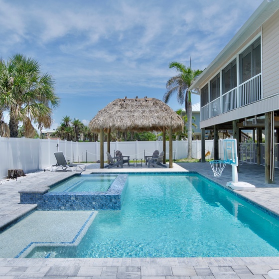 Relax and unwind in your private pool with a luxurious spillover spa.