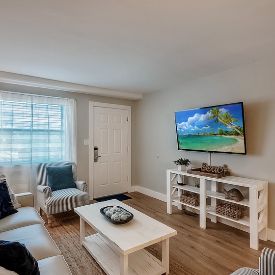 Welcome to Venus 106 - The Salty Sister! Sink into plush seating while your favorite shows play on the large screen TV in this bright, coastal-themed living space.