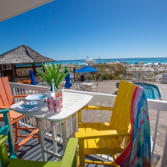 Wake up to stunning Gulf views from your private balcony, where colorful beach chairs and tropical touches create the perfect spot for morning coffee.