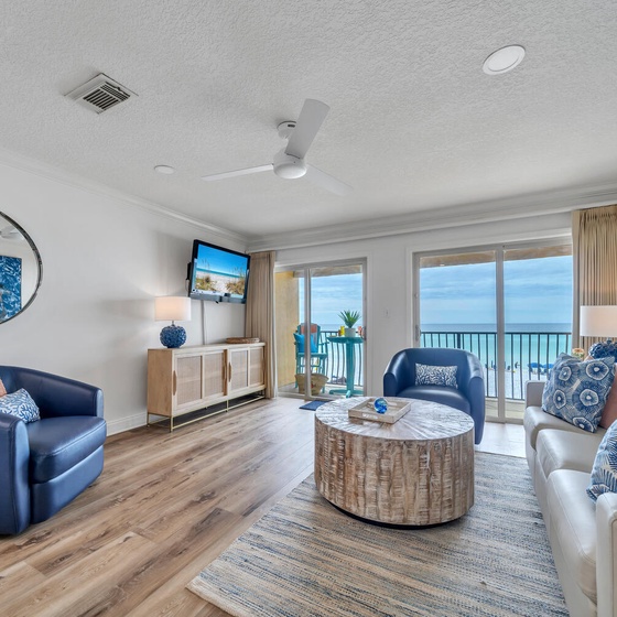 Relax in your coastal living room with ocean-themed décor, watching the waves through floor-to-ceiling windows that frame endless sea views.