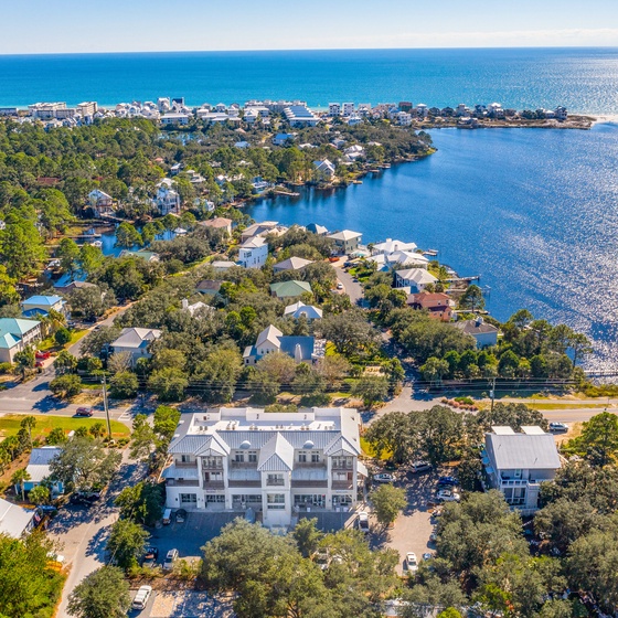 Stunning aerial view showcases this coastal property's prime location just minutes to the beach and right next to Old Florida Fish House and Beachy Bean