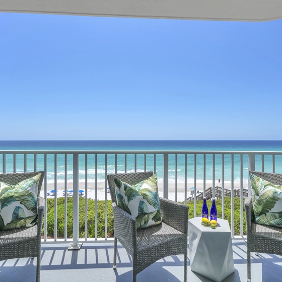 Sip your morning coffee on your private oceanfront balcony, watching waves roll onto pristine white sand below.