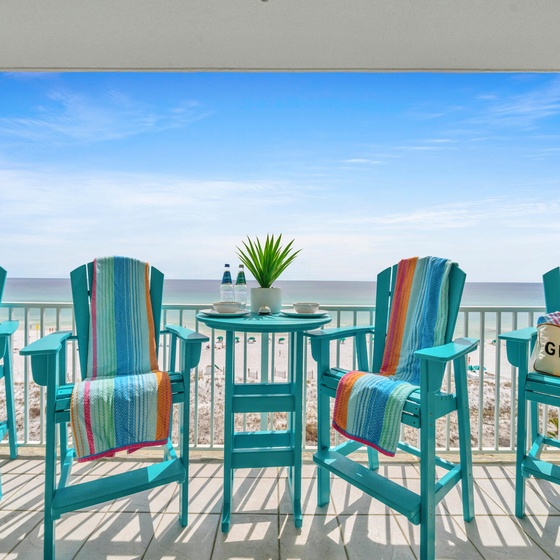 Picture yourself sipping morning coffee on your private balcony, surrounded by vibrant turquoise chairs and gulf breezes.