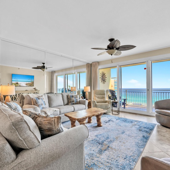 Sink into plush seating while ocean breezes flow through your spacious living room, where floor-to-ceiling windows frame endless sea views.