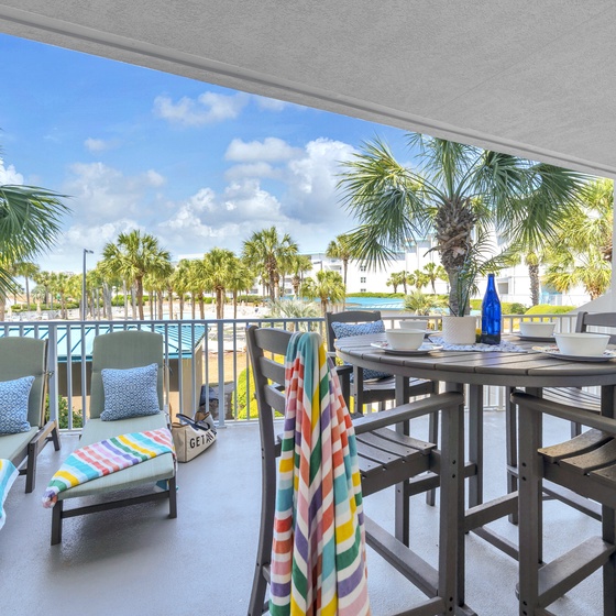 Sip your morning coffee while soaking in stunning pool and palm tree views from your private covered balcony.