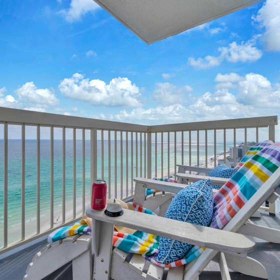 Step onto your private balcony where colorful lounge chairs await your morning coffee ritual, with stunning ocean views stretching endlessly before you.