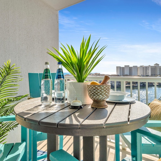 Your private waterfront balcony with tropical plants where you can sip morning coffee while watching boats glide across the sparkling water below.