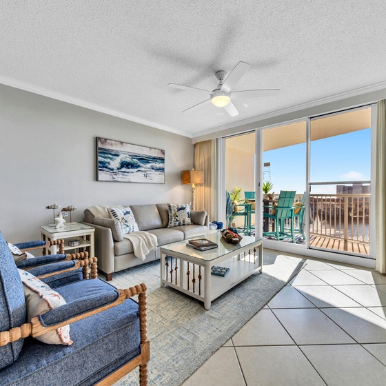 Sink into plush coastal-themed seating while ocean breezes flow through your balcony doors, creating the perfect beach retreat atmosphere.