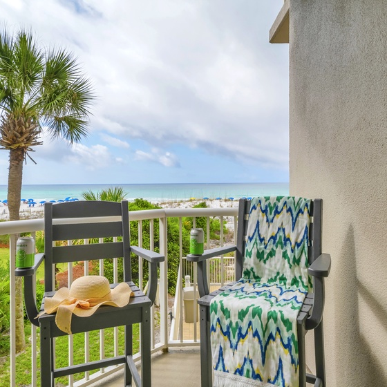 Your private balcony offers stunning oceanfront views with comfortable seating to savor morning coffee while watching waves roll onto pristine sand.