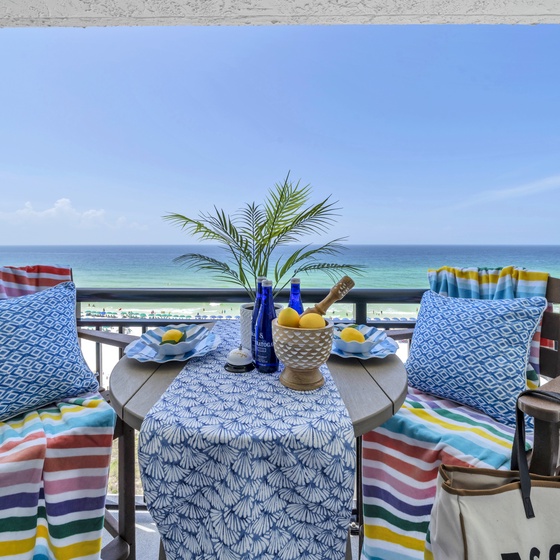 Sip tropical drinks on your private beachfront balcony with direct beach access and stunning turquoise waters stretching to the horizon.