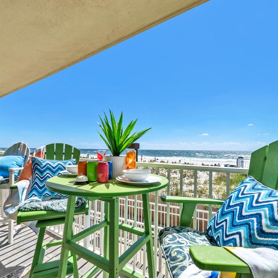 Your private oceanfront balcony awaits with vibrant seating and coastal breezes for morning coffee or sunset cocktails.