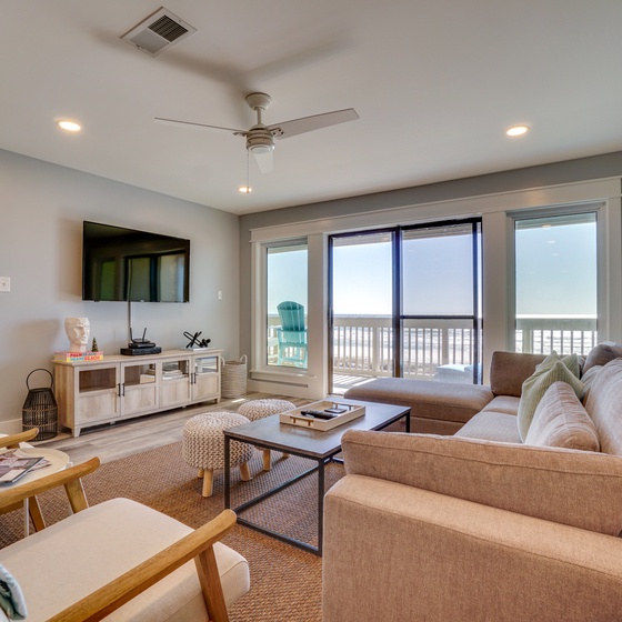 Unwind in your spacious living room with plush seating, modern entertainment, and stunning ocean views from your private balcony.