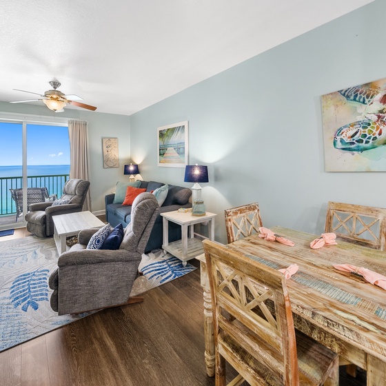 Unwind in your coastal living room with stunning ocean views through floor-to-ceiling windows and comfortable seating for memorable evenings together.
