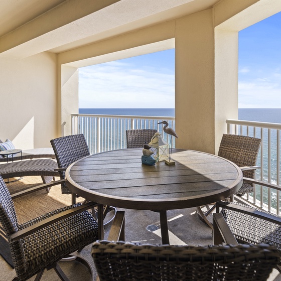 Your private oceanfront balcony awaits with comfortable wicker seating and endless sea views for morning coffee or sunset dining.