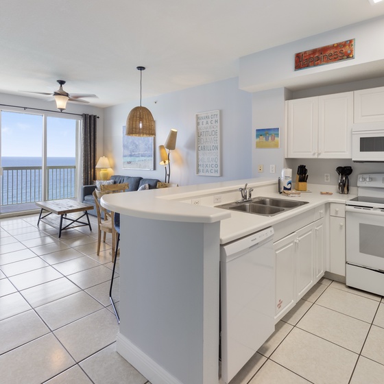 Step into your coastal escape where the kitchen flows seamlessly into a sun-drenched living space. Enjoy stunning ocean views from your private balcony while you prepare meals or relax in comfort.