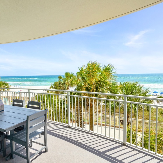 Dine al fresco on your private balcony with stunning ocean views, swaying palms, and endless turquoise waters stretching to the horizon.