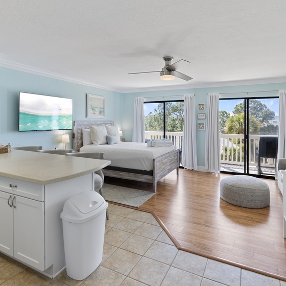 Relax in your bright coastal suite with king bed, bunk beds, kitchenette, and balcony access—perfect for families seeking comfort and convenience.