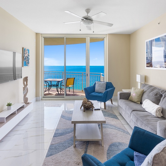 Unwind in your coastal retreat where ocean views stretch endlessly beyond floor-to-ceiling windows, inviting sea breezes through your private balcony.