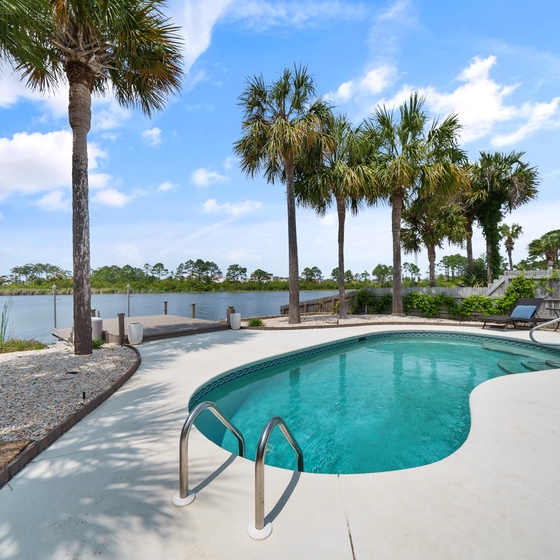 Private pool paradise with stunning lake views and swaying palm trees creating your perfect tropical retreat.